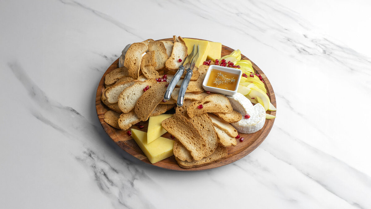 Cheese board with crackers and honey