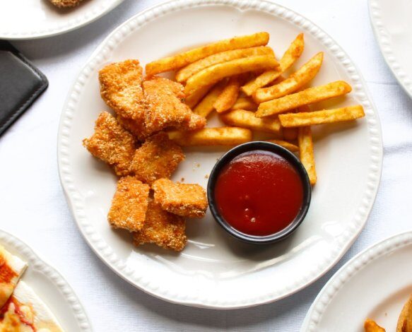 Crumbed chicken bites with chips and tomato sauce