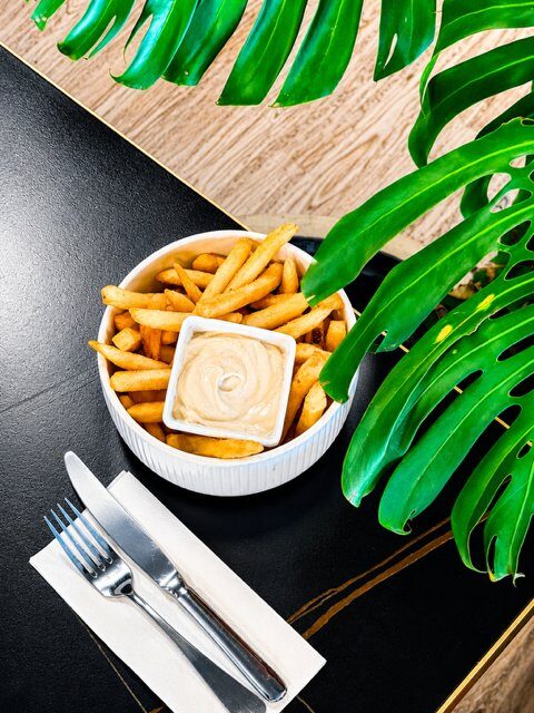 Crispy golden vegan fries with vegan aioli