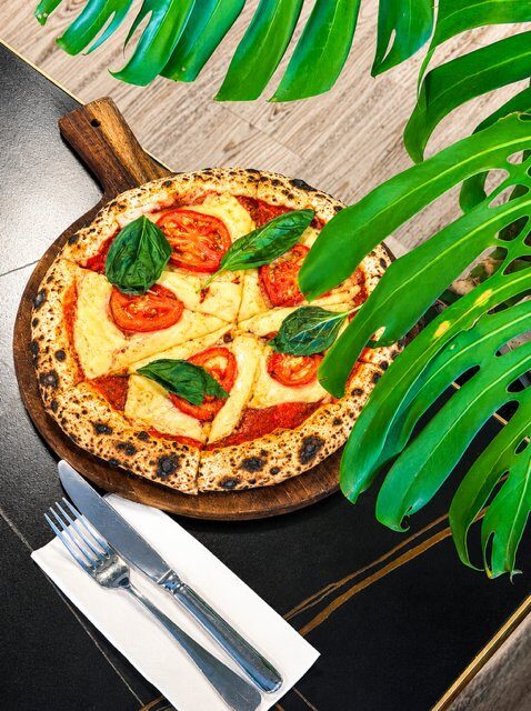 Classic Margherita pizza with vegan cheese, tomato, basil on gluten free base